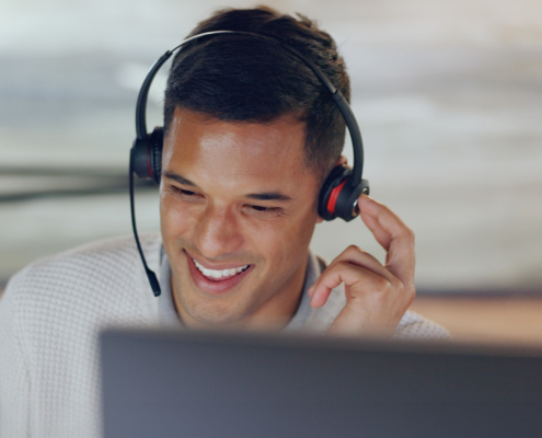 Front view of man smiling and talking on headset